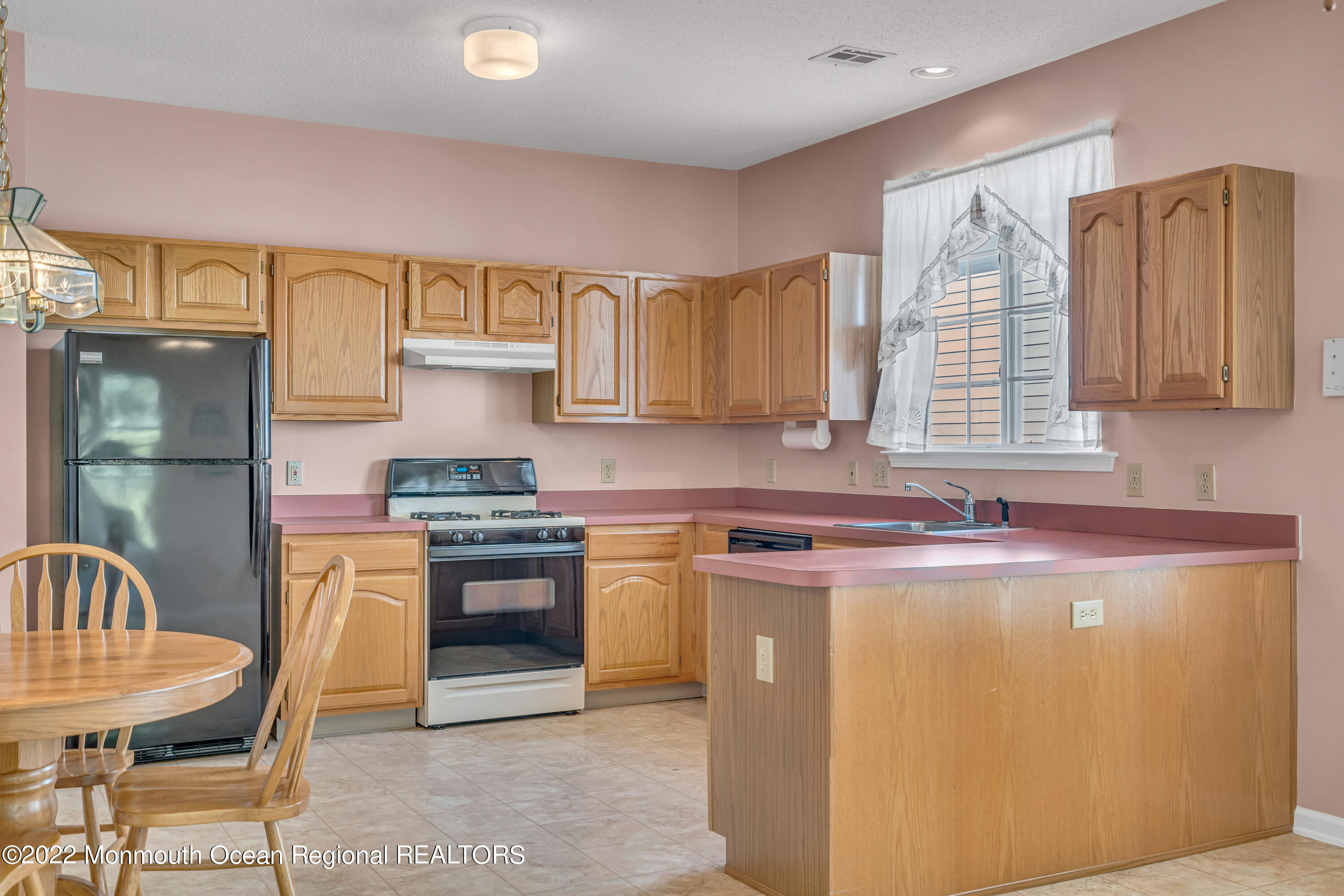 59 Quail Road Barnegat, NJ 08005 - Photo 12 of 30 a kitchen with stainless steel appliances granite countertop a stove a sink and a refrigerator