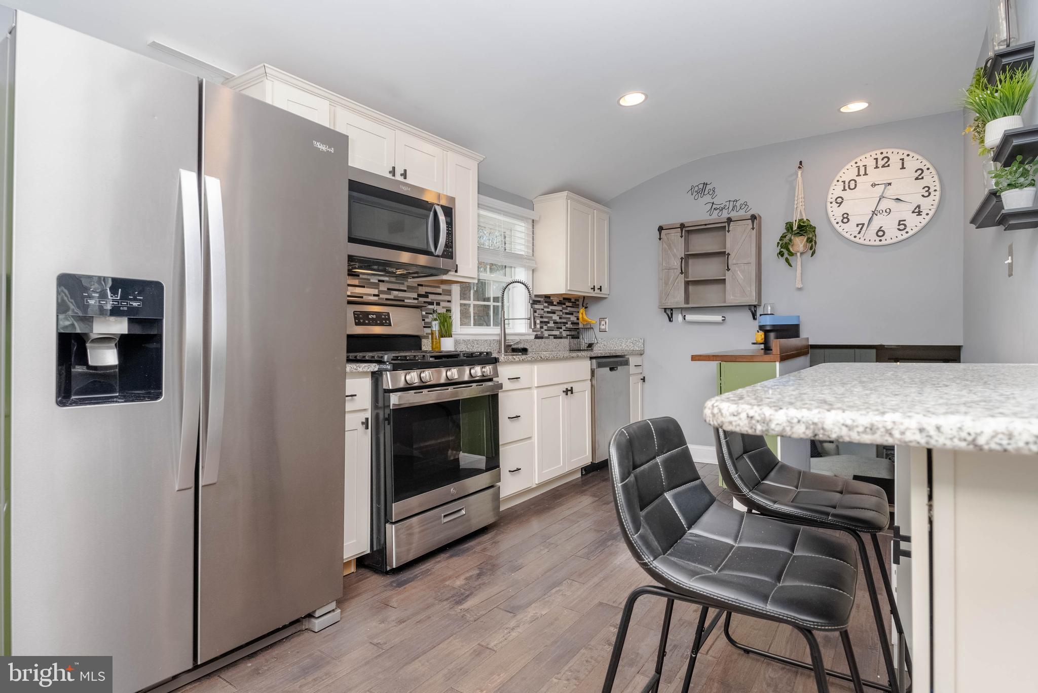 438 Chestnut Street Aberdeen, MD 21001 - Photo 5 of 28 a kitchen with stainless steel appliances granite countertop a stove refrigerator and a refrigerator with wooden floor