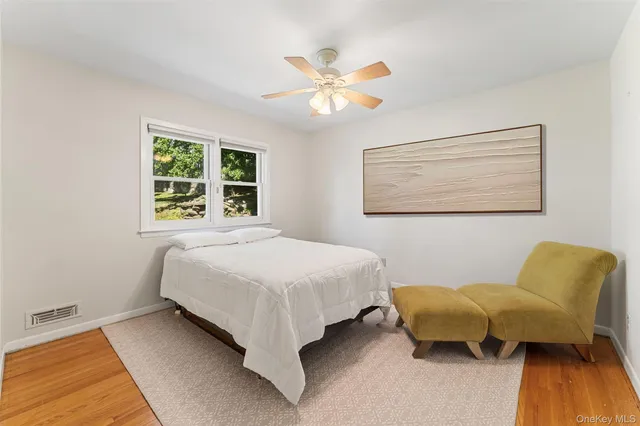 a bedroom with a bed and chair