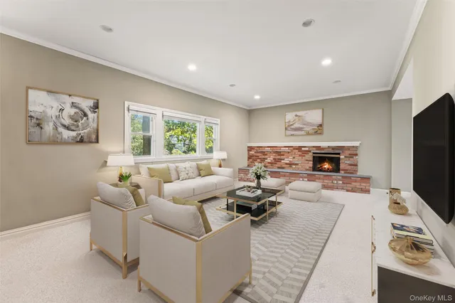 a living room with furniture a flat screen tv and a fireplace