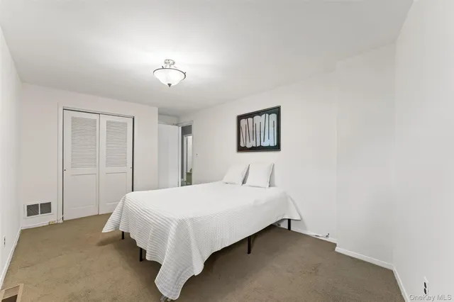 a bedroom with a bed and a night stand