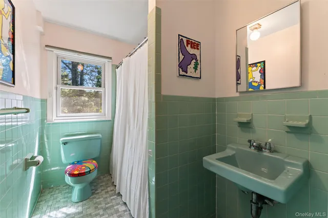a bathroom with a sink mirror and toilet