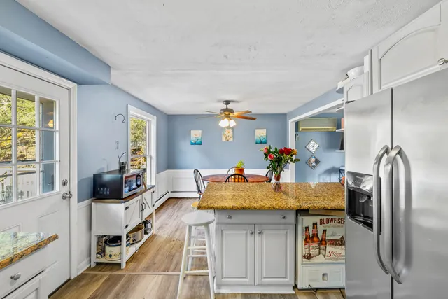 a kitchen with stainless steel appliances granite countertop a sink refrigerator and microwave