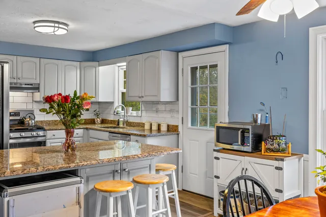 a kitchen with a refrigerator and a sink
