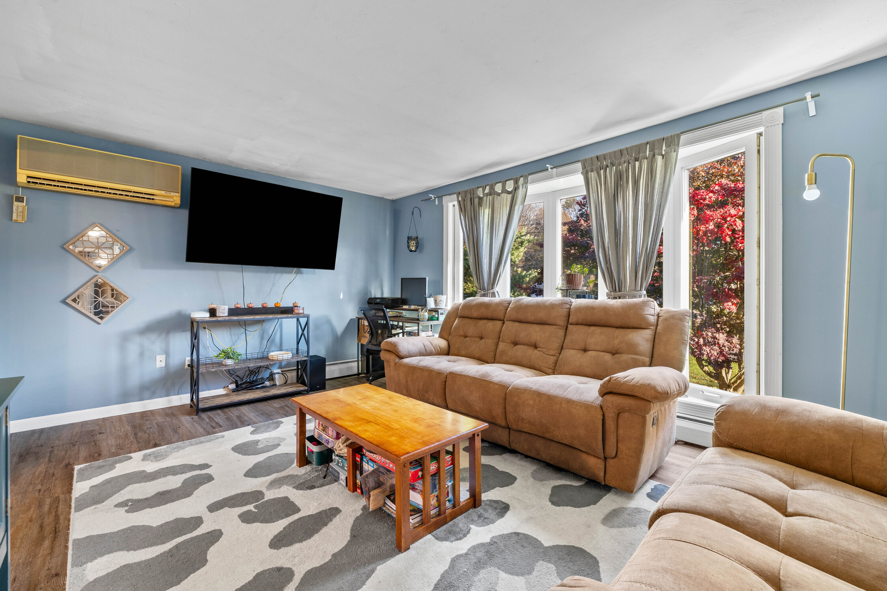 4 Van Dyke Lane Clinton, CT 06413 - Photo 14 of 38 a living room with furniture a flat screen tv and a floor to ceiling window