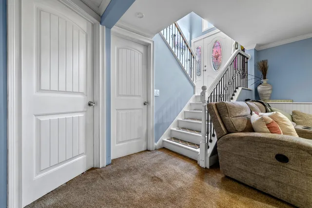 a living room with furniture and stairs