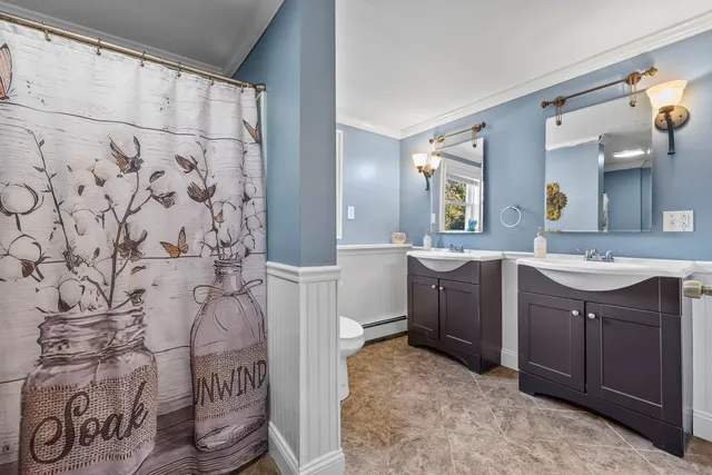 a spacious bathroom with a sink and a mirror