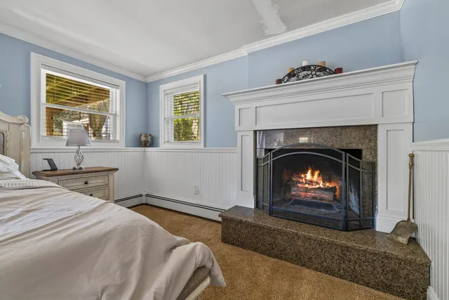 a bedroom with a bed and a fireplace