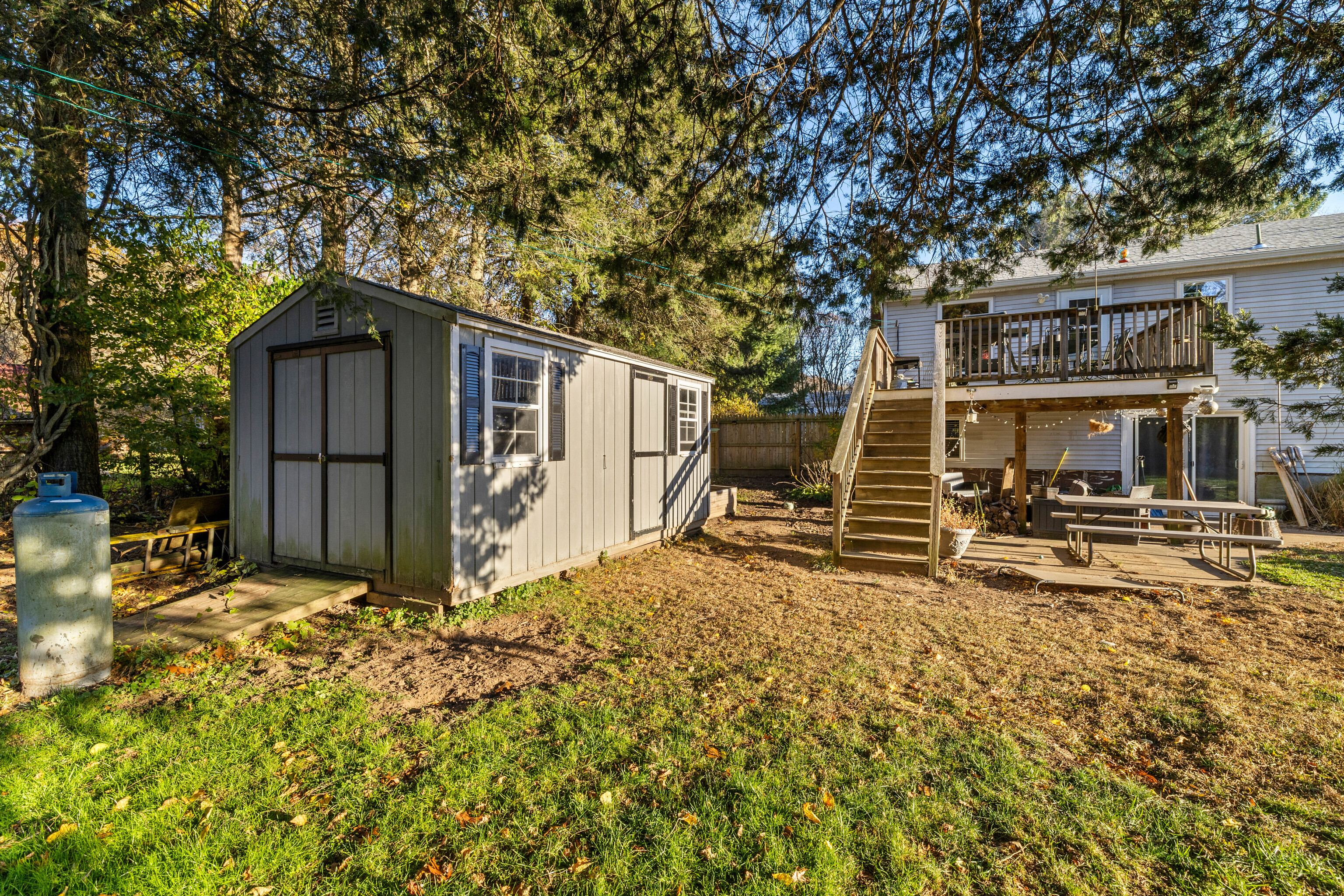 4 Van Dyke Lane Clinton, CT 06413 - Photo 35 of 38 a backyard of a house with large trees and wooden fence