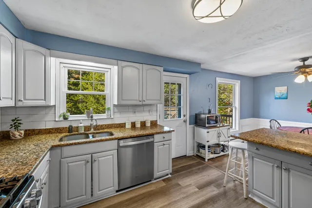 a kitchen with a sink stove and cabinets