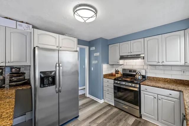 a kitchen with stainless steel appliances a refrigerator a stove and cabinets