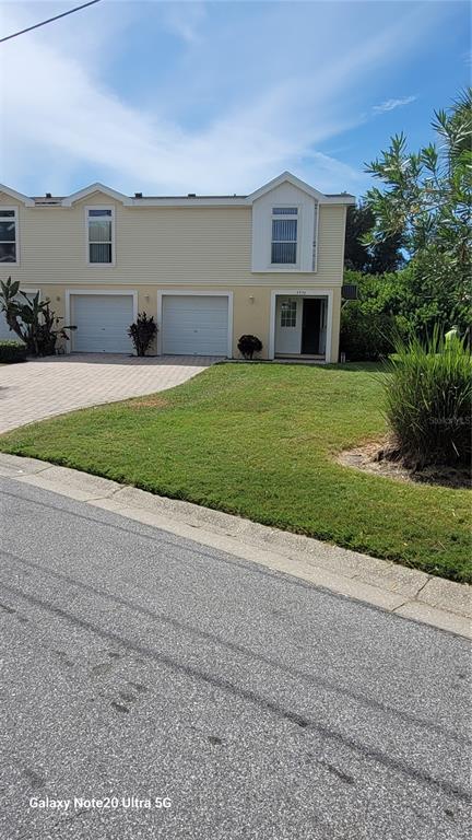 4936 Marina Palms Drive Port Richey, FL 34668 - Photo 1 of 19 a front view of a house with a yard and garage