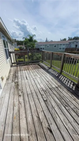 a view of a balcony with wooden floor