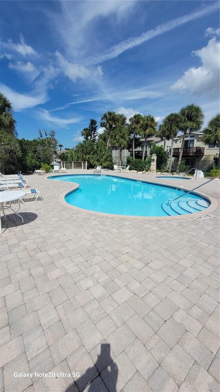 4936 Marina Palms Drive Port Richey, FL 34668 - Photo 19 of 19 a view of a swimming pool and an outdoor seating