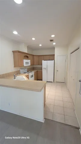 a kitchen with a stove top oven and cabinets