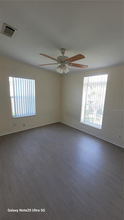 4936 Marina Palms Drive Port Richey, FL 34668 - Photo 7 of 19 an empty room with windows and ceiling fan view