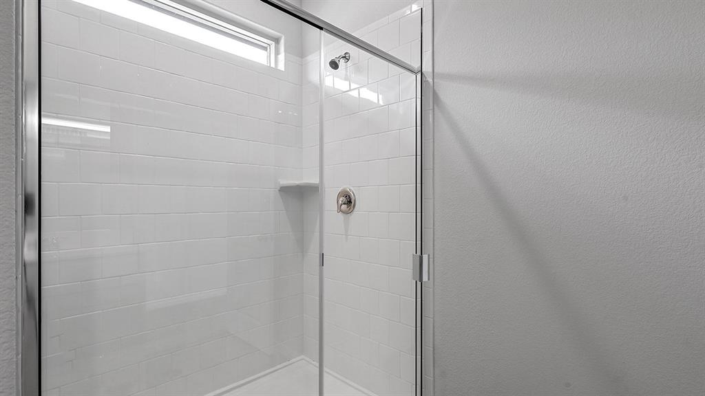 140 Trinity Street Grandview, TX 76050 - Photo 20 of 39 a bathroom with a glass shower door