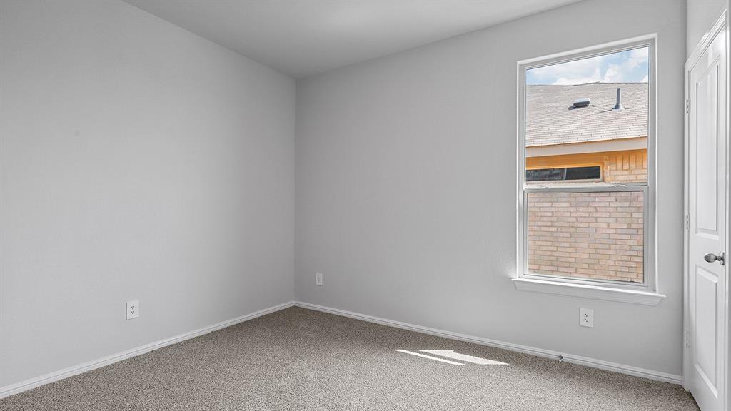 140 Trinity Street Grandview, TX 76050 - Photo 23 of 39 a view of an empty room with a window