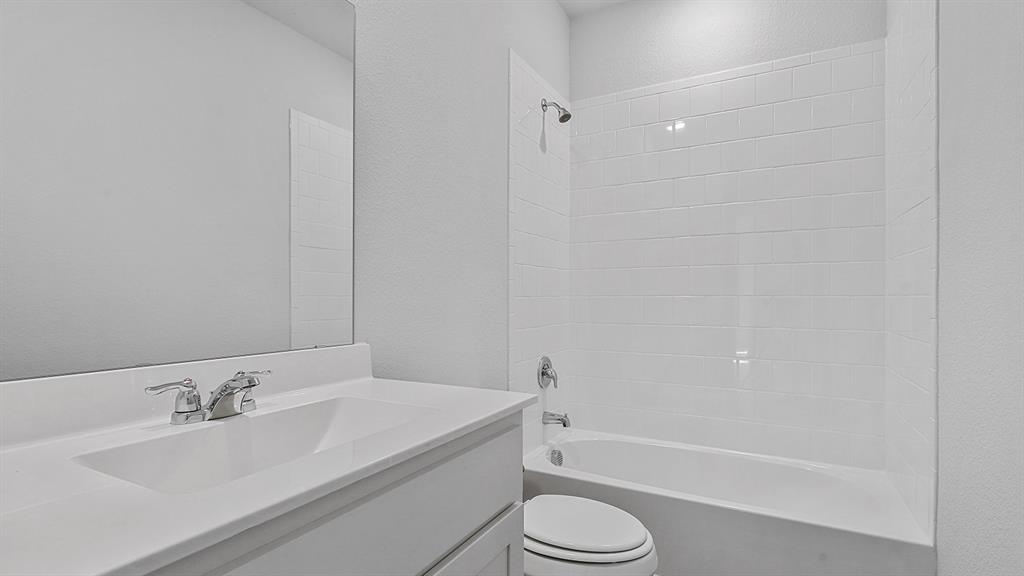 140 Trinity Street Grandview, TX 76050 - Photo 28 of 39 a bathroom with a granite countertop sink toilet and bathtub