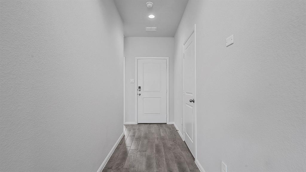 140 Trinity Street Grandview, TX 76050 - Photo 33 of 39 a view of a hallway with wooden floor
