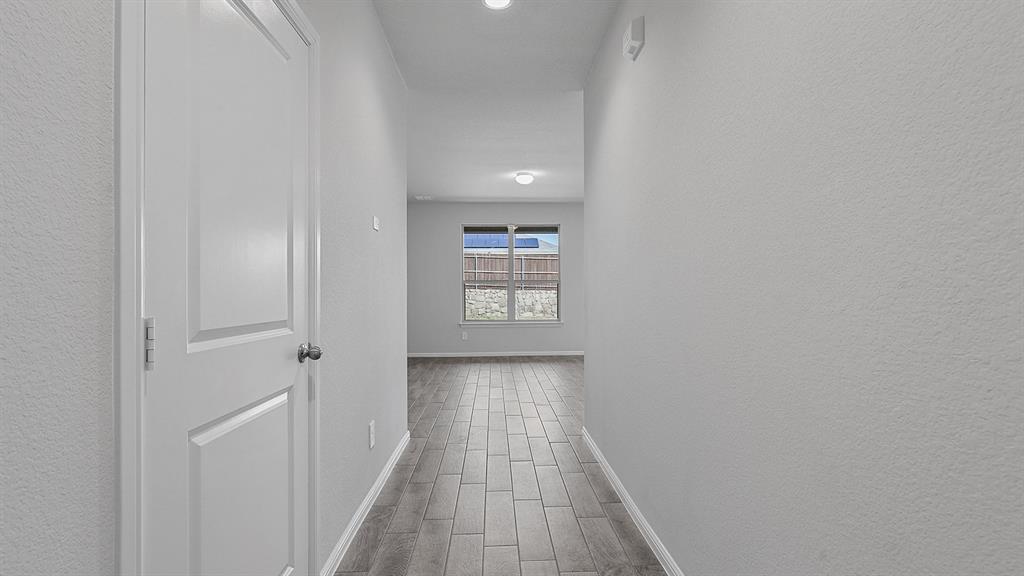140 Trinity Street Grandview, TX 76050 - Photo 34 of 39 a view of a hallway with wooden floor