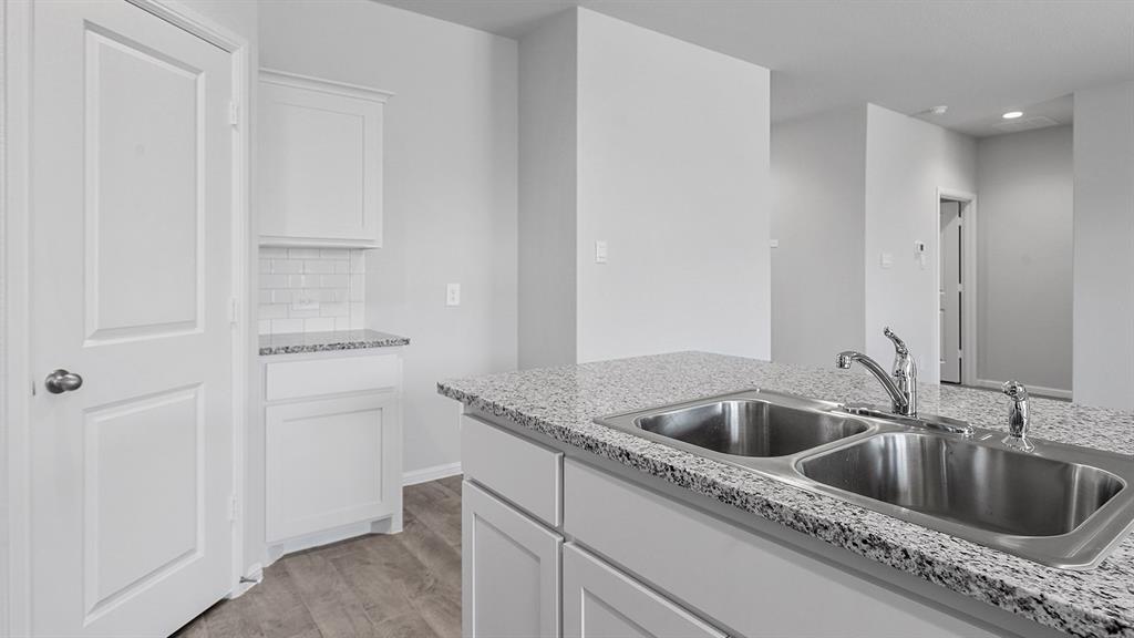 140 Trinity Street Grandview, TX 76050 - Photo 5 of 39 a close view of a sink and refrigerator in kitchen