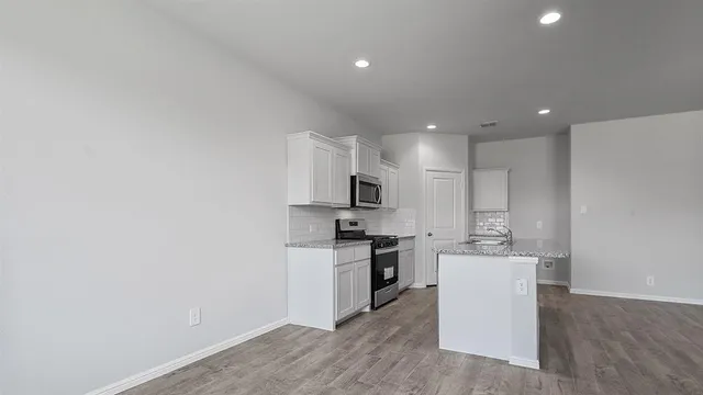 a close view of a sink and refrigerator in kitchen