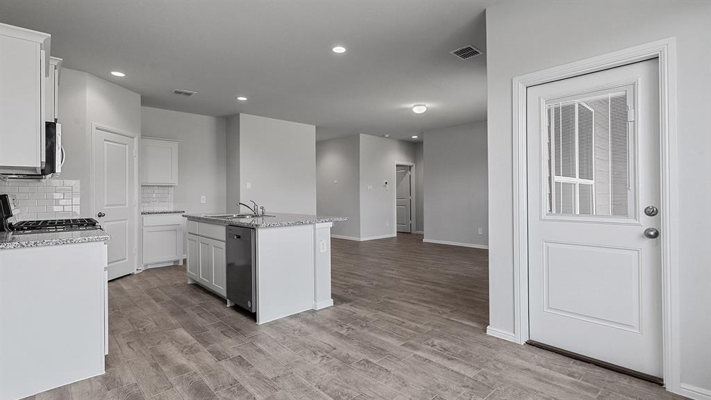 140 Trinity Street Grandview, TX 76050 - Photo 8 of 39 a view of a kitchen with electric appliances