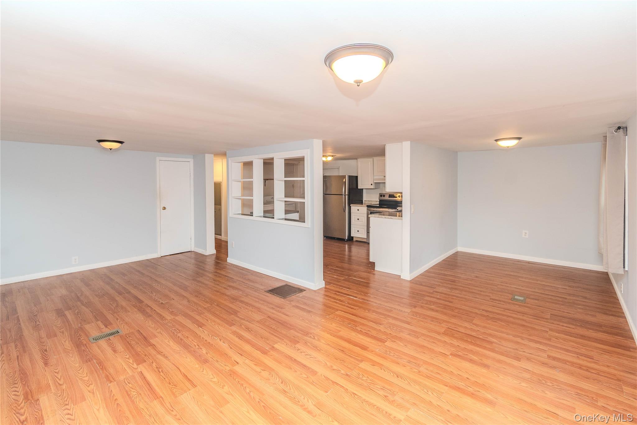 198 Sinpatch Road, Unit 16 Wassaic, NY 12592 - Photo 7 of 26 Wood-finish flooring throughout, light-toned wall paint, and multiple ceiling-mounted light fixtures
