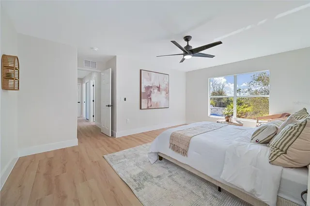 a bedroom with a large bed and a chandelier