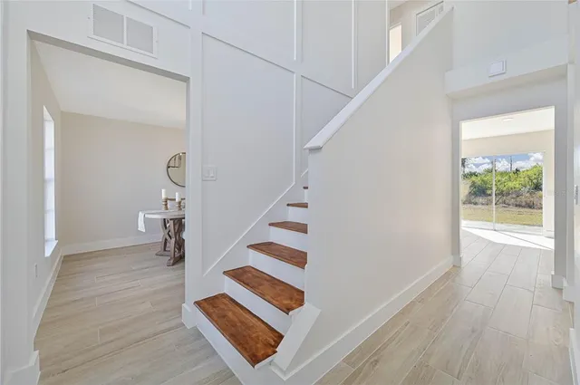 a view of entryway and hall with wooden floor