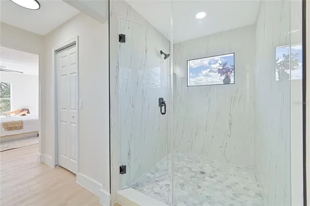 a bedroom with a bed and windows