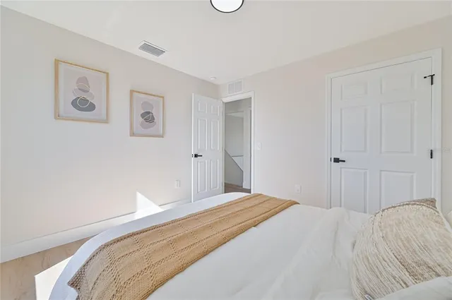 a bedroom with a bed and lamps