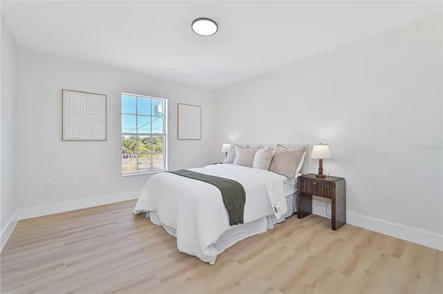 a bedroom with a bed and a lamp