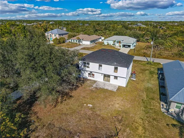 an aerial view of a house with a yard
