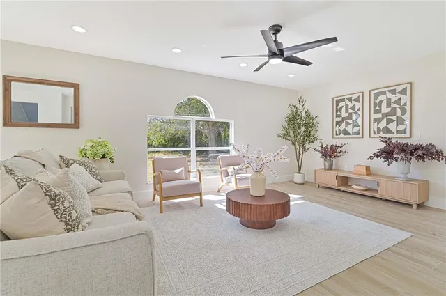 a living room with furniture and a potted plant
