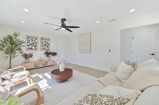 a living room with furniture and a wooden floor