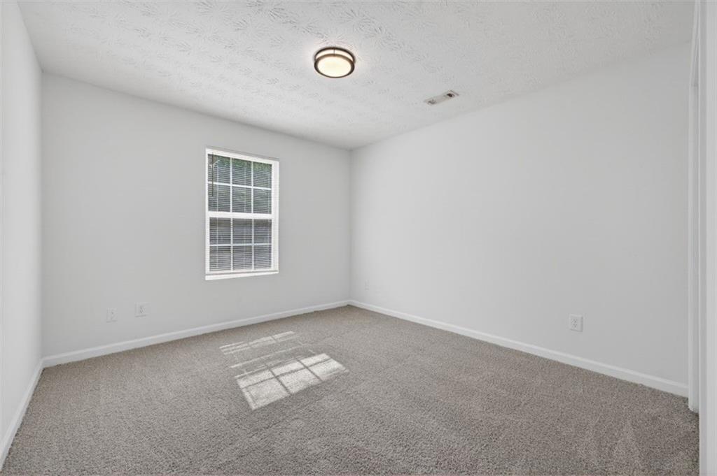 1424 Steam Engine Way Northeast Conyers, GA 30013 - Photo 12 of 32 an empty room with a window