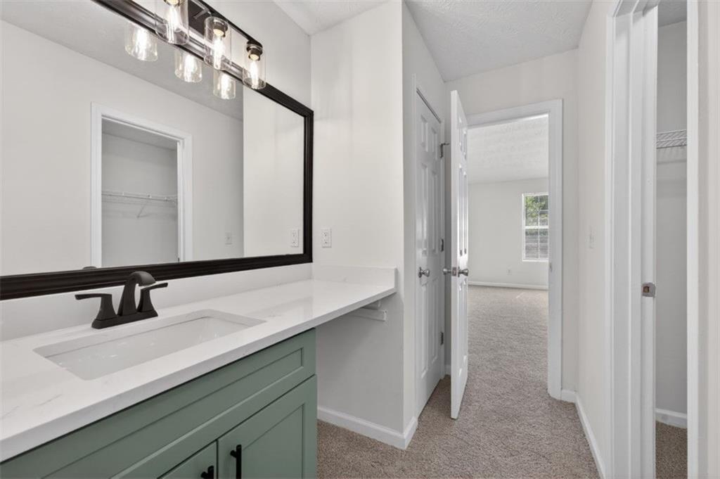 1424 Steam Engine Way Northeast Conyers, GA 30013 - Photo 19 of 32 a bathroom with a double vanity sink and a mirror