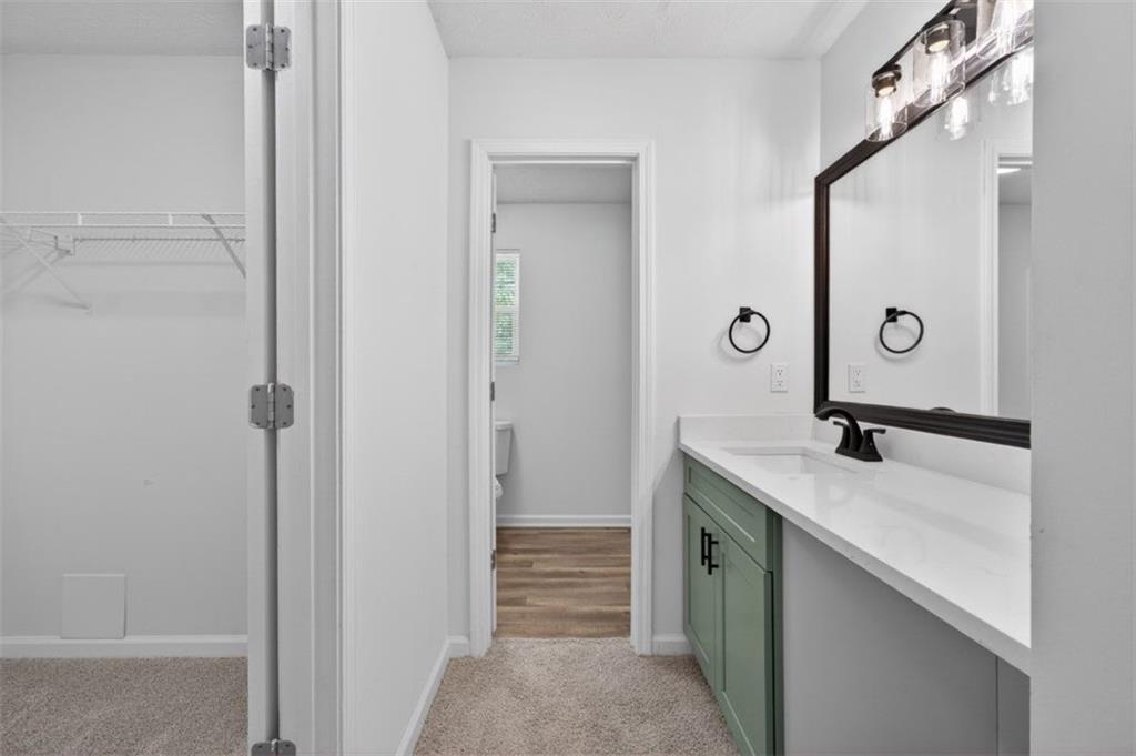 1424 Steam Engine Way Northeast Conyers, GA 30013 - Photo 20 of 32 a bathroom with a sink and mirror