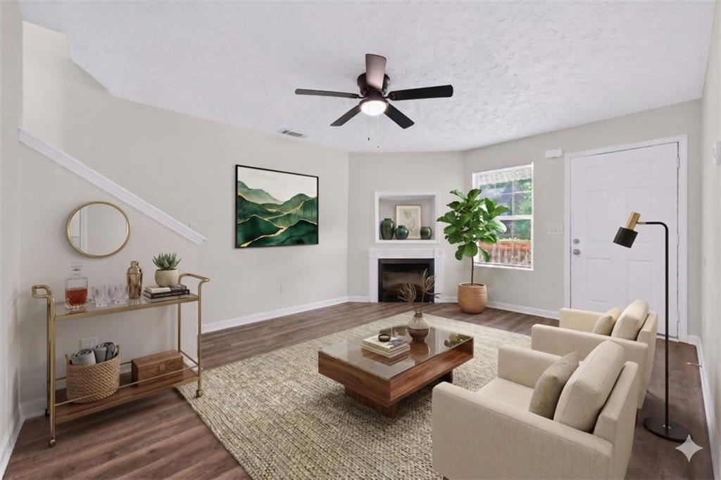 1424 Steam Engine Way Northeast Conyers, GA 30013 - Photo 2 of 32 a living room with furniture a fireplace and a window