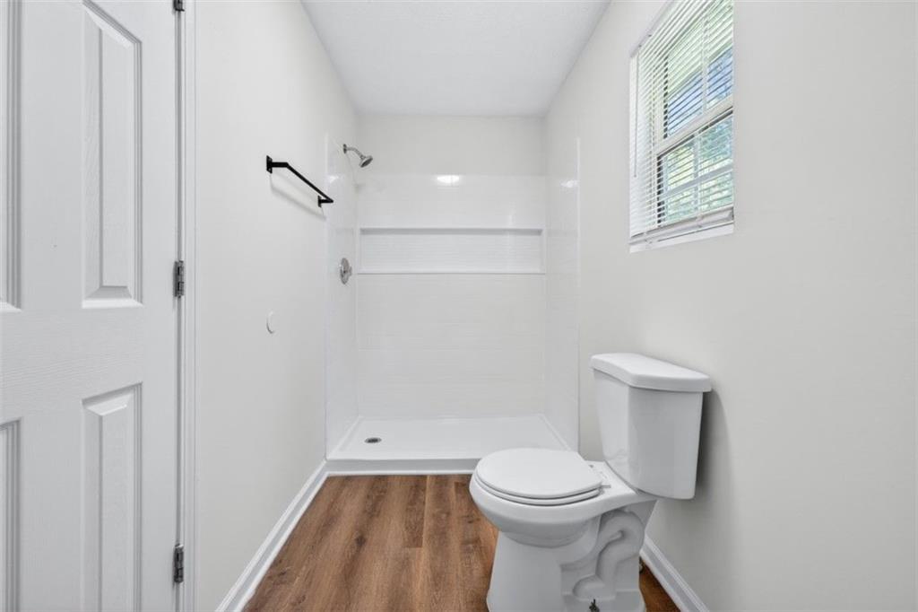 1424 Steam Engine Way Northeast Conyers, GA 30013 - Photo 21 of 32 a bathroom with a toilet sink and shower