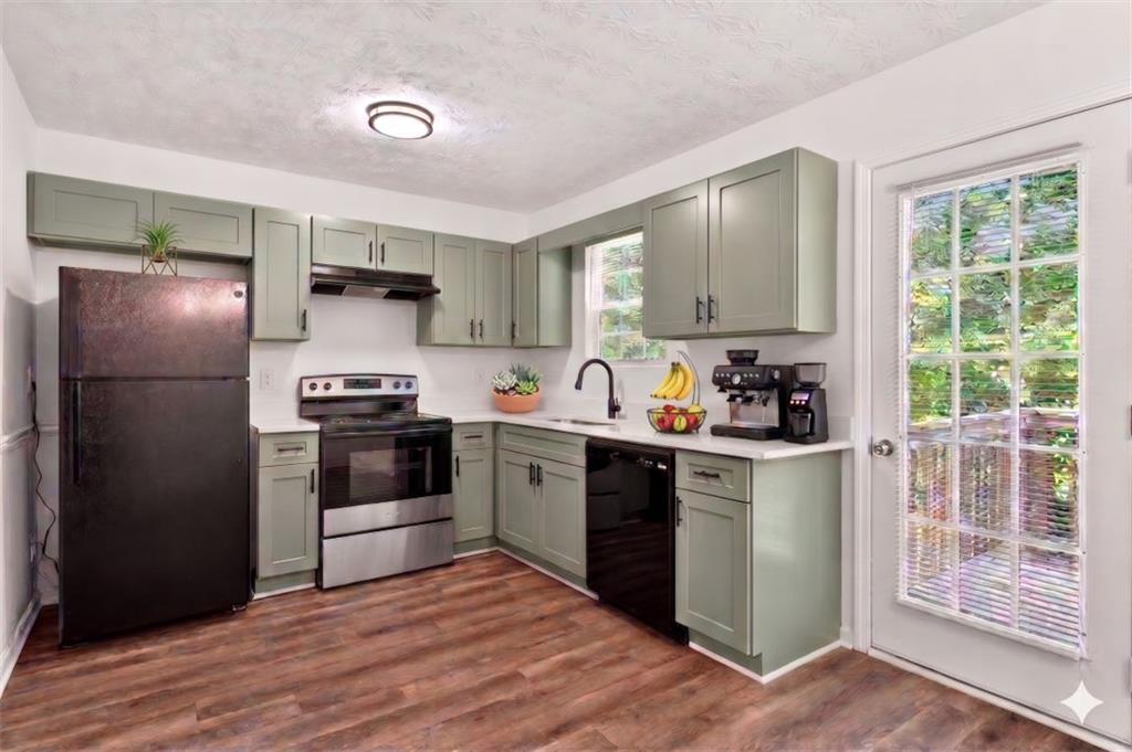 1424 Steam Engine Way Northeast Conyers, GA 30013 - Photo 3 of 32 a kitchen with a refrigerator stove and sink