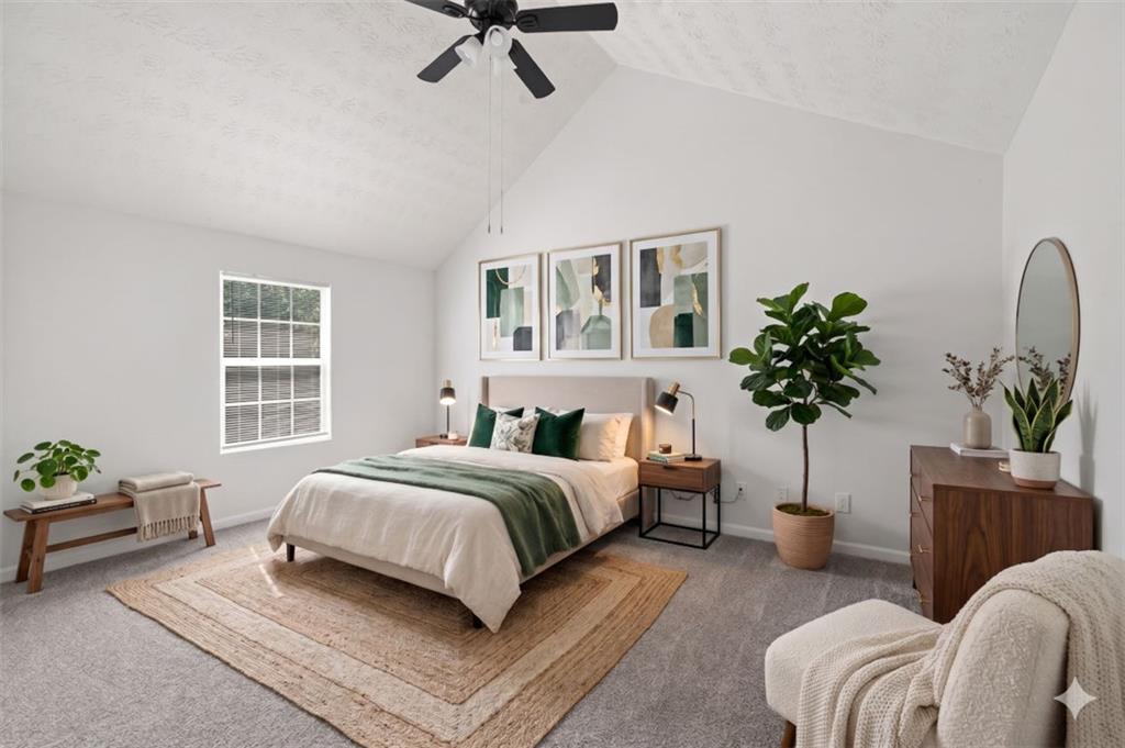 1424 Steam Engine Way Northeast Conyers, GA 30013 - Photo 4 of 32 a bedroom with a bed a couch and potted plant