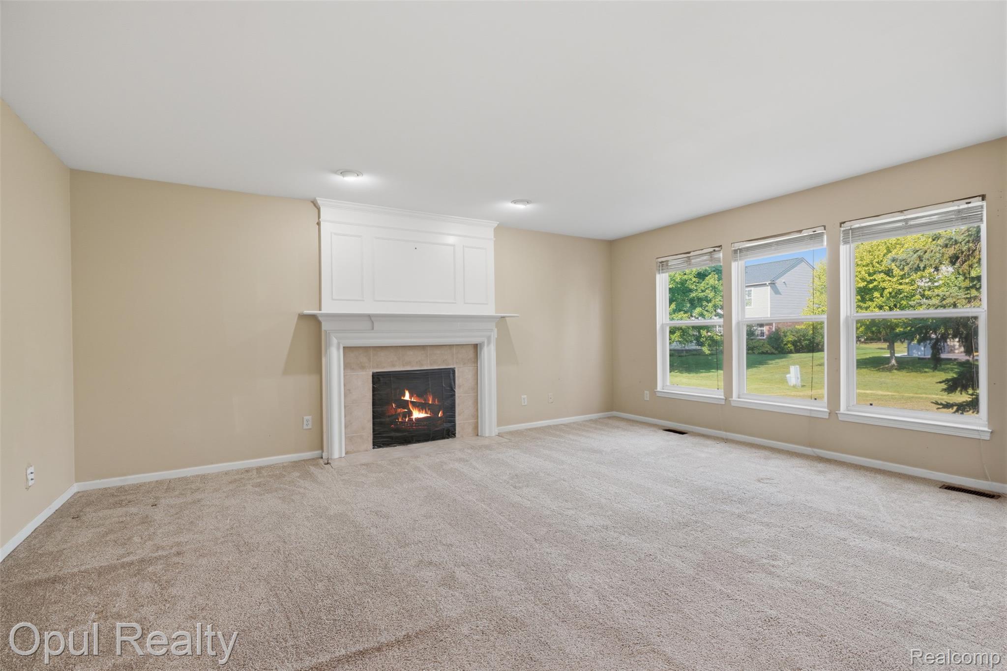 4530 Pond Run Canton, MI 48188 - Photo 10 of 43 Living room featuring a fireplace with a white mantel and light-toned tile surround