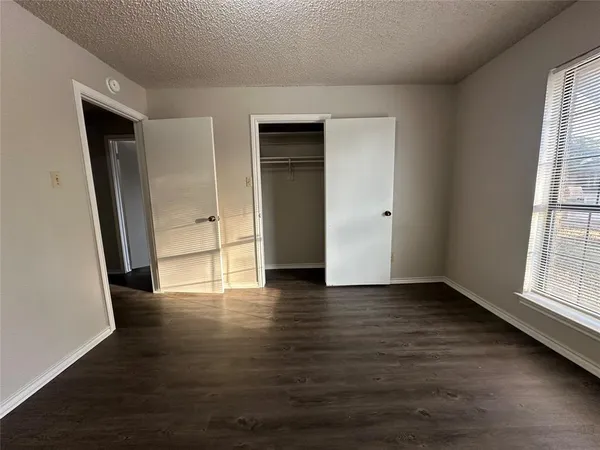 a spacious bathroom with a granite countertop sink and a mirror