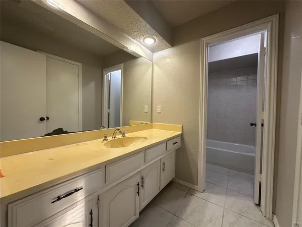 a white toilet sitting next to a bath tub