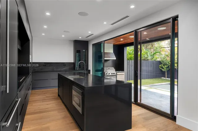 a kitchen with stainless steel appliances granite countertop sink stove and refrigerator