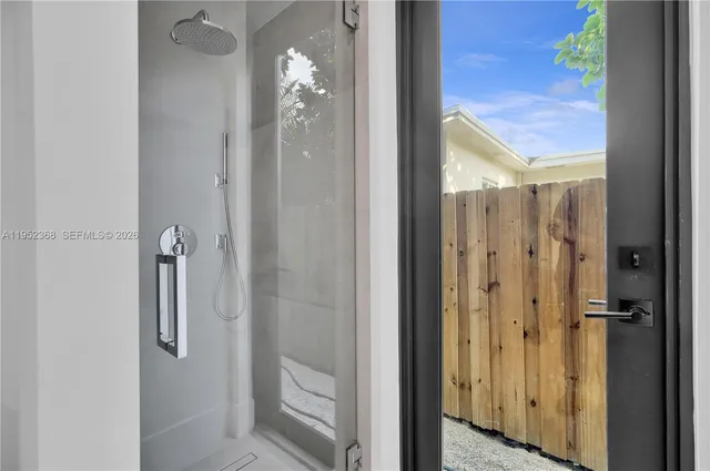 a bathroom with a glass shower door