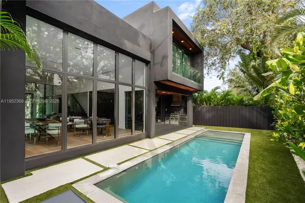 a view of a patio with table and chairs and potted plants